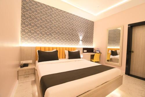 a bedroom with a large bed in a room at Hotel Sai Swastik in Puri