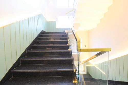 a staircase in a building with a stair case at Hotel Sai Swastik in Puri