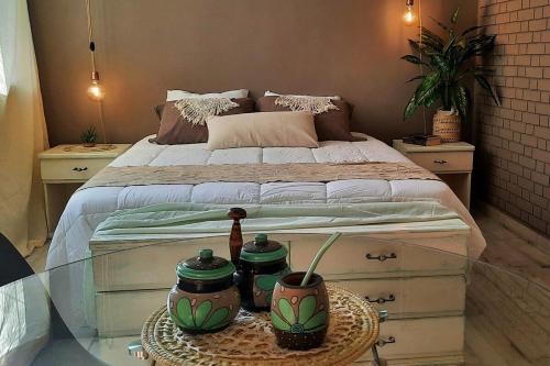 a bedroom with a bed and a glass table at Departamento Arístides Origen y Encanto en Mendoza in Mendoza