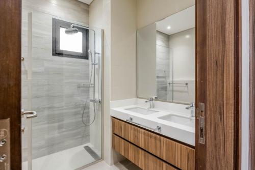a bathroom with a sink and a shower at RAKvista Residence in Ras al Khaimah