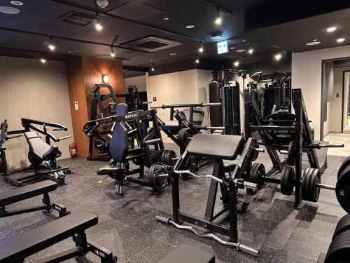 a gym with lots of treadmills and weights at the b ikebukuro in Tokyo