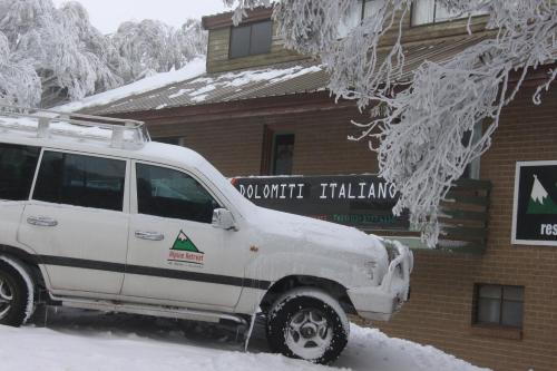 a white van parked in the snow in front of a building at Alpine Retreat Mt Buller in Mount Buller