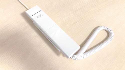 a white nintendo wii phone sitting on a table at Toyoko Inn Kobe Sannomiya Ekimae in Kobe