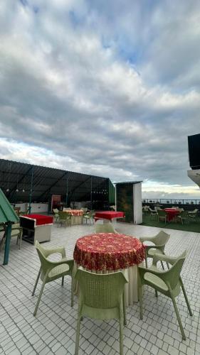 a patio with a table and chairs and tables at Peaks And Pines Resort in Lansdowne