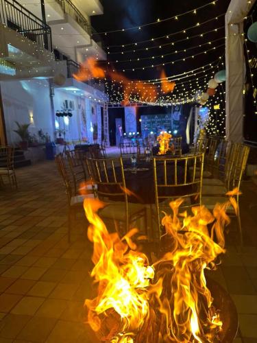a fire pit in a restaurant with chairs and a table at Peaks And Pines Resort in Lansdowne