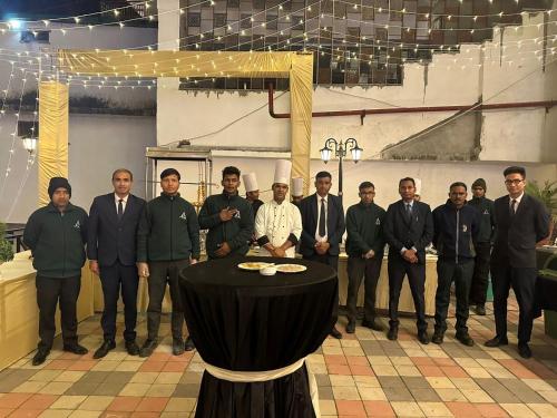 a group of men standing around a table in a room at Peaks And Pines Resort in Lansdowne