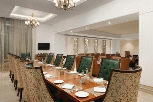 a large conference room with a long table and chairs at Ramada Plaza By Wyndham, Chandigarh Zirakpur in Chandīgarh