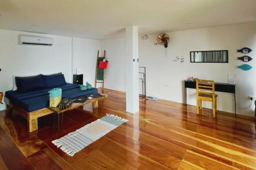 a living room with a blue couch and a table at Txaleta de Camiguin desde 2024 in Mambajao