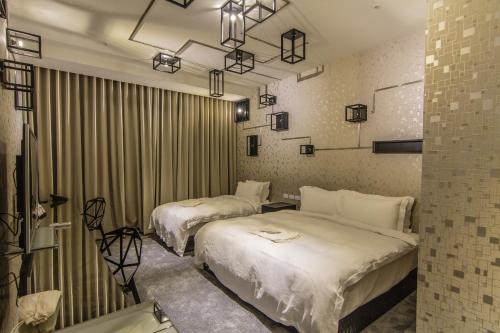 a hotel room with two beds in a room at The Tree House in Kaohsiung