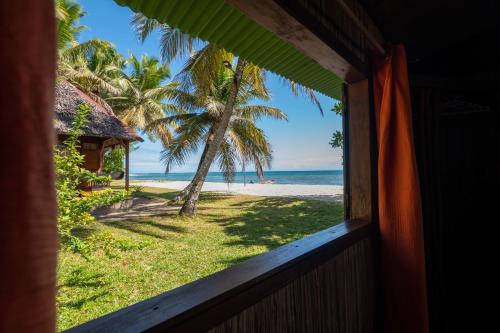 a window view of the beach from a resort at Maningory in Ile aux Nattes