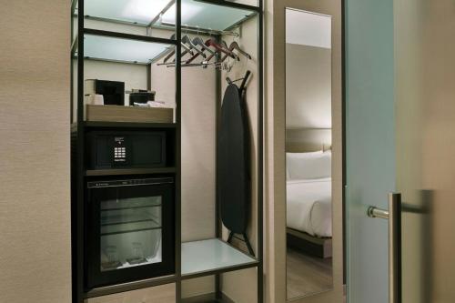 a bathroom with a mirror and a microwave in a room at AC Hotel Seattle Downtown in Seattle