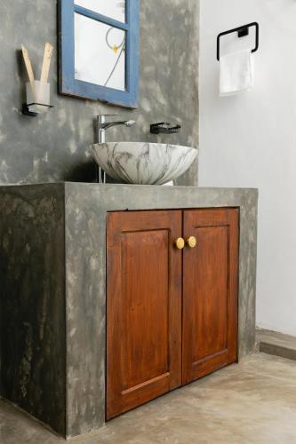 a bathroom with a sink and a mirror at THE LODGE by Eco Love in Galle