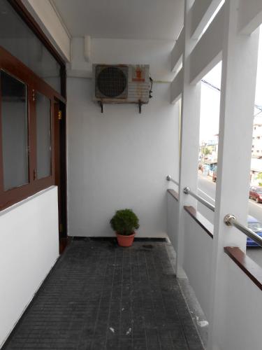 a hallway with a fan and a potted plant at Coral Seas Beach Hikkaduwa in Hikkaduwa