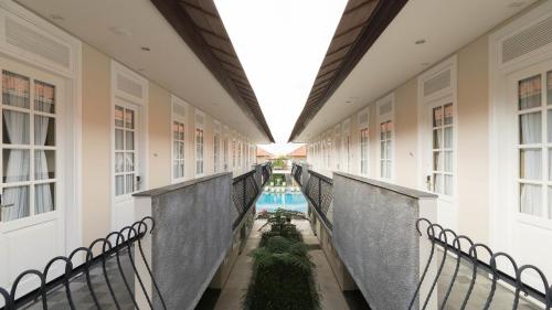 an internal corridor of a building with a pool at SOLTERRA SEMINYAK Boutique Hotel & Spa Powered by Archipelago in Seminyak