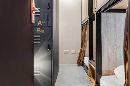 a door leading into a room with a bedroom at Getcha Hostel in Taichung
