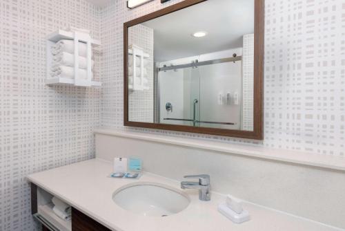 a bathroom with a sink and a mirror at Hampton Inn and Suites Clearwater Beach in Clearwater Beach