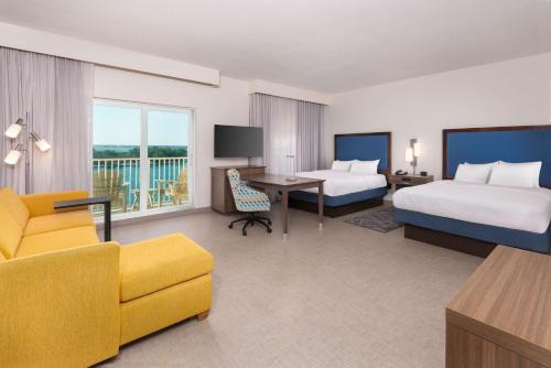 a hotel room with two beds and a desk at Hampton Inn and Suites Clearwater Beach in Clearwater Beach