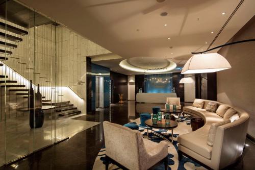 a living room with a couch and a table at Hilton Istanbul Bomonti in Istanbul