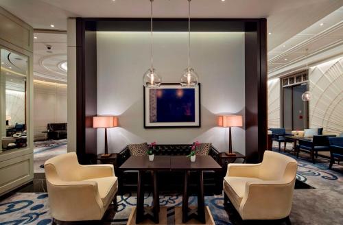 a hotel lobby with a table and chairs at Hilton Istanbul Bomonti in Istanbul