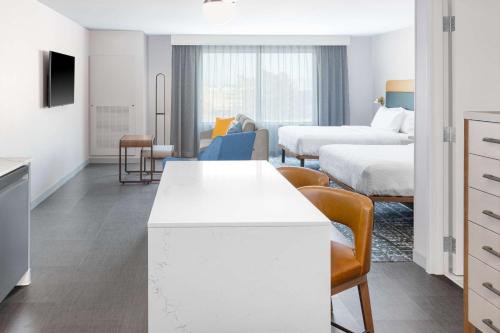 a kitchen and living room with two beds and a living room at Homewood Suites By Hilton Holland in Holland