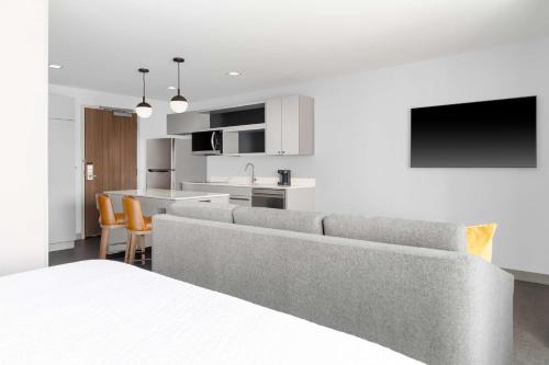 a living room with a couch and a kitchen at Homewood Suites By Hilton Holland in Holland