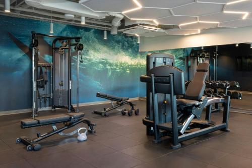 a gym with several tread machines and a wall mural at Marriott Vacation Club, Waikiki in Honolulu