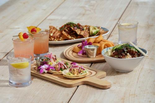 a table topped with plates of food and drinks at Marriott Vacation Club, Waikiki in Honolulu