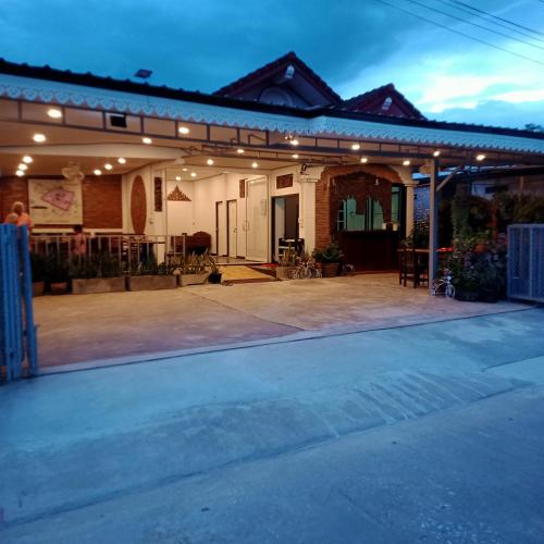 a house with an outdoor patio at night at บ้านจัสมิน in Sukhothai