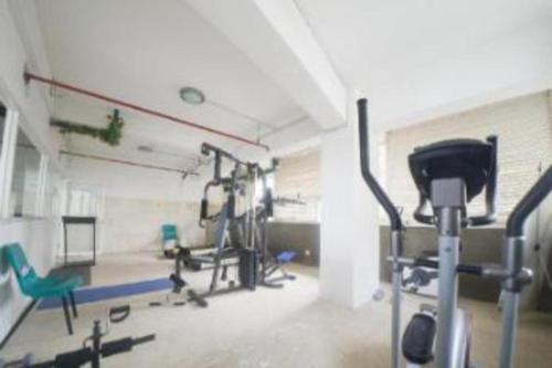 a gym with two exercise bikes in a room at Pavilion Permata Hotel Manage By Occupied in Surabaya