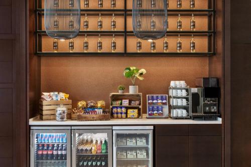 a coffee shop with a refrigerator and drinks at Residence Inn by Marriott Munich City East in Munich