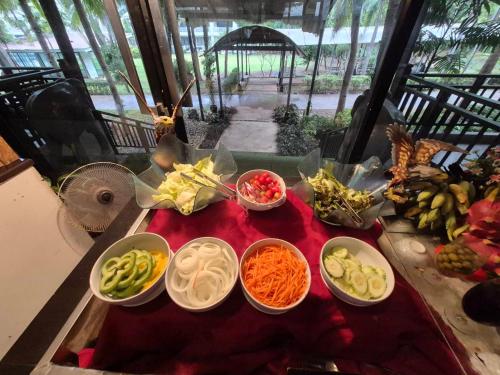 a table topped with bowls of different types of food at Ramada by Wyndham Aonang Krabi in Ao Nang Beach