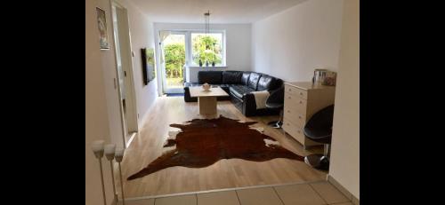 a living room with a black couch and a table at Modern & Spacious apartment in Silkeborg