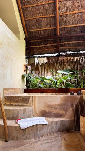 a towel sitting on the steps of a building at The Nest Tropical Oasis Resort in Paje