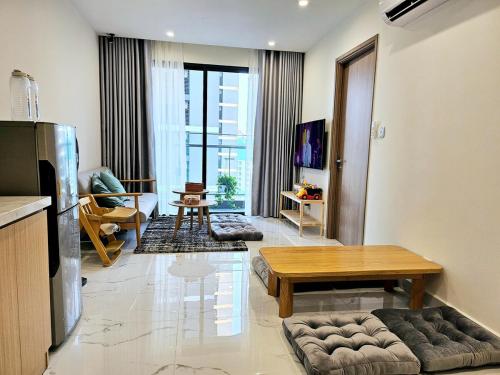 a living room with a couch and a table at Dinosaurs House - New apartment, Vinhome Grand Park-2BR,2WC, 5 guests in Gò Công