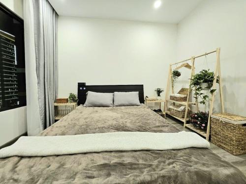 a bedroom with a large bed and two baskets at Dinosaurs House - New apartment, Vinhome Grand Park-2BR,2WC, 5 guests in Gò Công