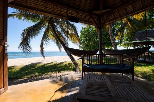 a hammock on a beach with a view of the ocean at Maningory in Ile aux Nattes