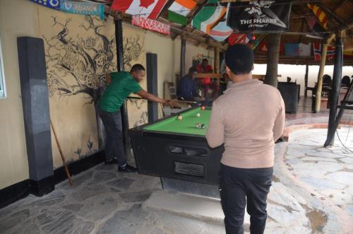 a couple of people playing a game of billiard at Lusaka Backpackers in Lusaka