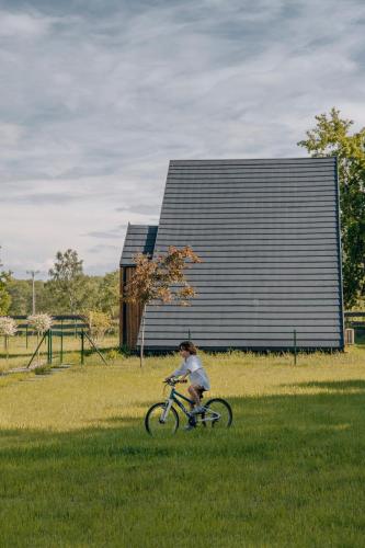 a person riding a bike in the grass at Zen Sasino in Sasino