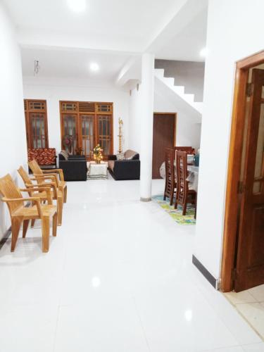 a living room with chairs and a couch at Uduwara Holiday Home in Badulla