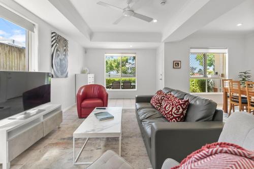 a living room with a couch and a table at The Villa on Shire - Comfort near Coorparoo Square in Brisbane