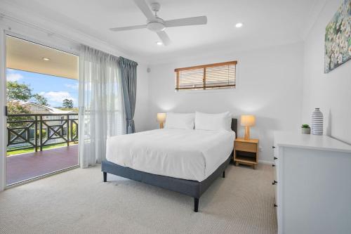 a bedroom with a bed and a balcony at The Villa on Shire - Comfort near Coorparoo Square in Brisbane