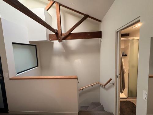 a staircase in a house with a vaulted ceiling at Devonport CBD Modern Loft in Devonport