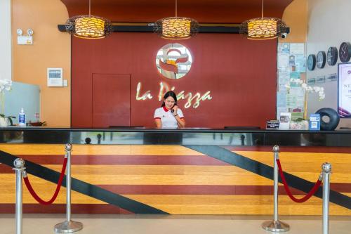 a woman standing behind the counter of a restaurant at La Piazza Hotel and Convention Center Inc. in Legazpi
