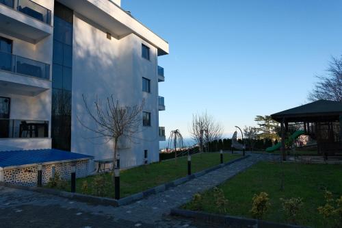 a building with a playground in front of it at Şahin Tepesi Suite Otel in Trabzon