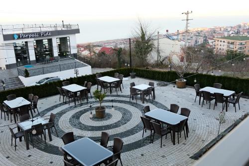 a group of tables and chairs on a patio at Şahin Tepesi Suite Otel in Trabzon