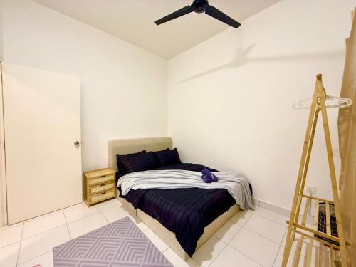 a bedroom with a bed and a ceiling fan at Alura Cove Bandar Bukit Raja, Setia Alam in Klang