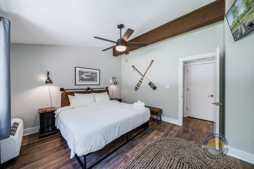 a bedroom with a white bed and a ceiling fan at YOUR New Luxury Lakeview Condo w Pool Access in Lake Geneva