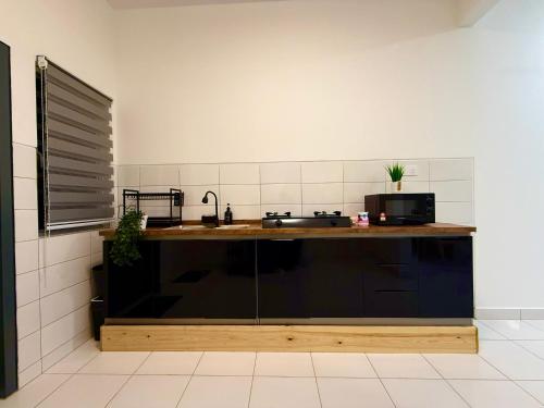 a kitchen with a sink and a counter at Alura Cove Bandar Bukit Raja, Setia Alam in Klang