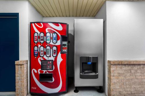 a coca cola vending machine with a pay phone at Americas Best Value Inn Houston Heights at I-45 in Houston