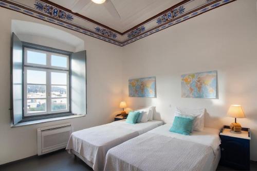 A bed or beds in a room at Villa 1853-Upper floor
